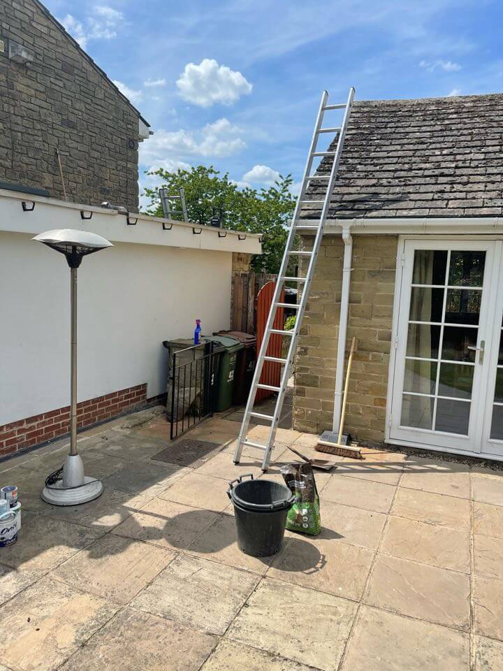 ladder against roof on a sunny day providing fascia repair in Leeds